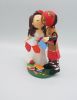 Picture of San Francisco 49ers fan groom & school teacher bride wedding cake topper