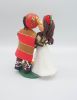 Picture of San Francisco 49ers fan groom & school teacher bride wedding cake topper