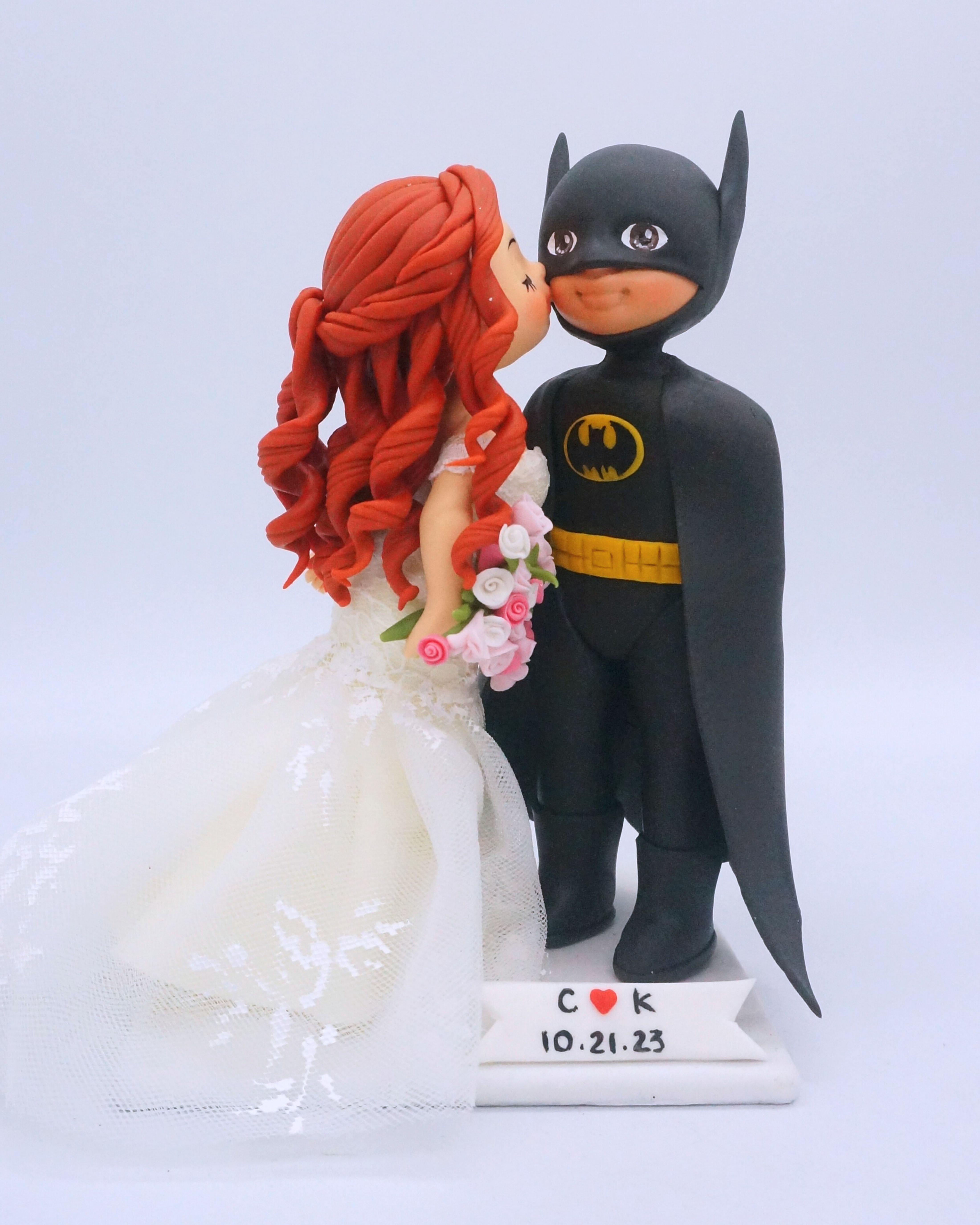 Picture of Batman Groom & Ariel Bride Wedding Cake Topper, Cheek Kiss Wedding Cake Topper